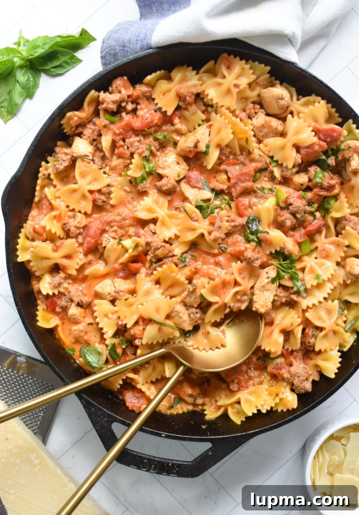 The Ultimate Creamy Chicken & Chorizo Pasta 8 Creamy Chicken and Chorizo Pasta Recipe with gold spoons.