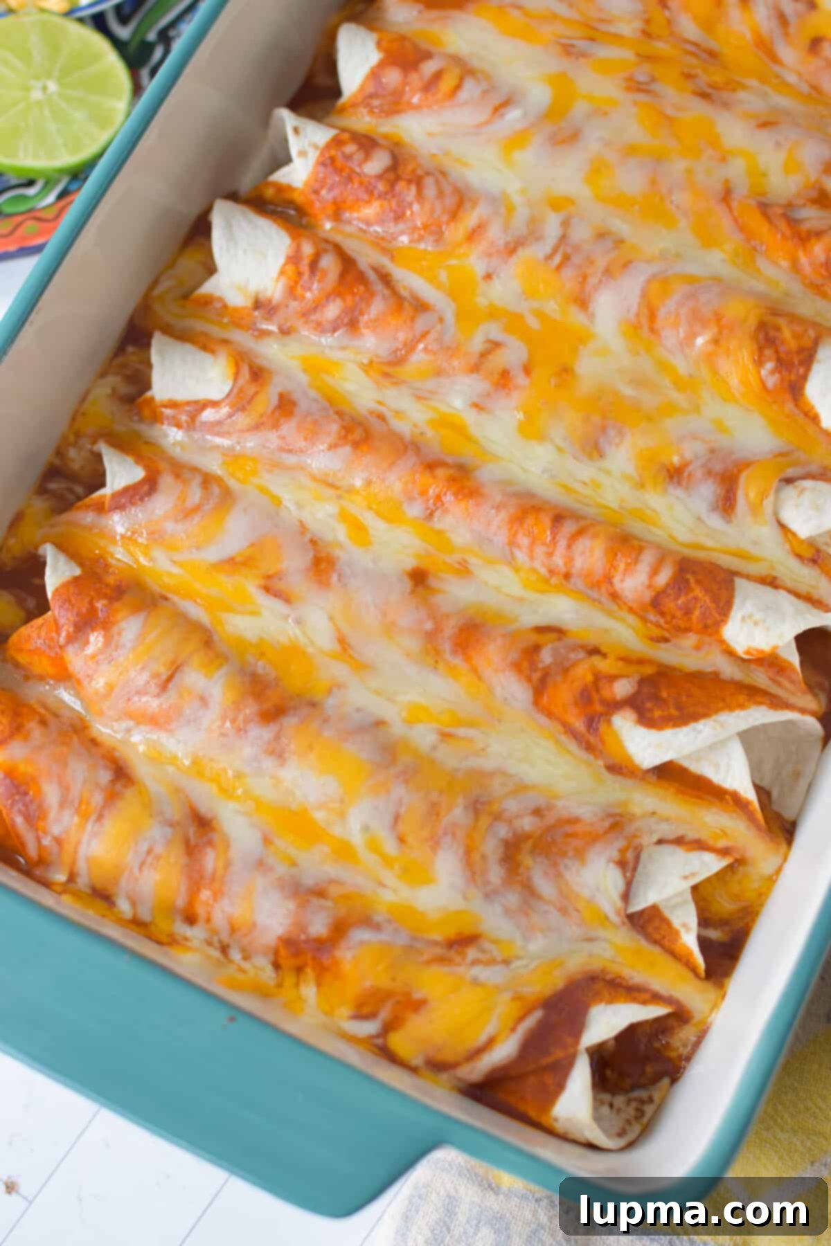 Speedy Pork Enchiladas 7 Freshly baked pork enchiladas right out of the oven, with perfectly melted, bubbly cheese on top, golden and inviting.