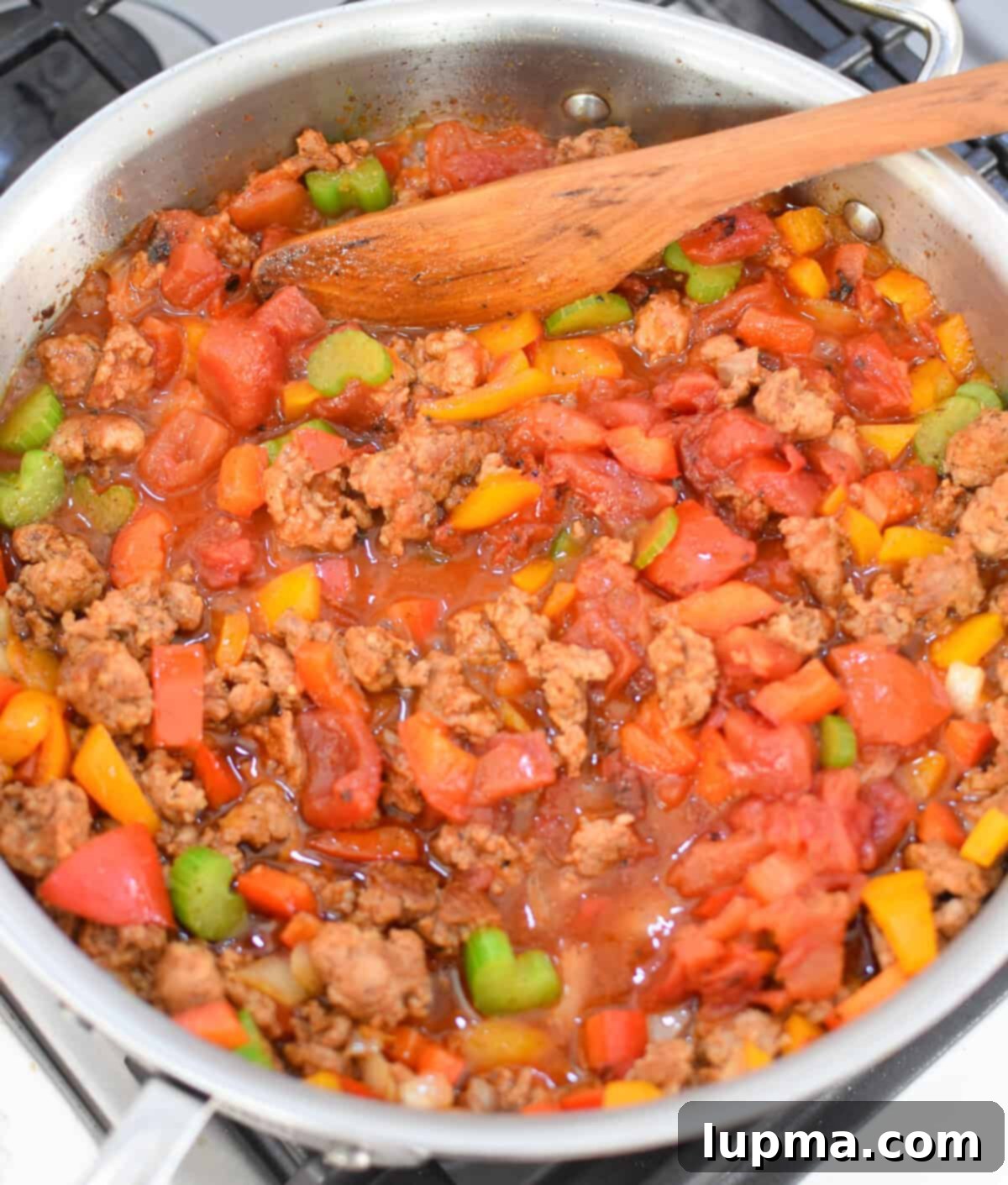 Hearty Creamy Cajun Sausage Rice Skillet 7 Creamy Cajun Sausage Rice Skillet with tomatoes in a skillet