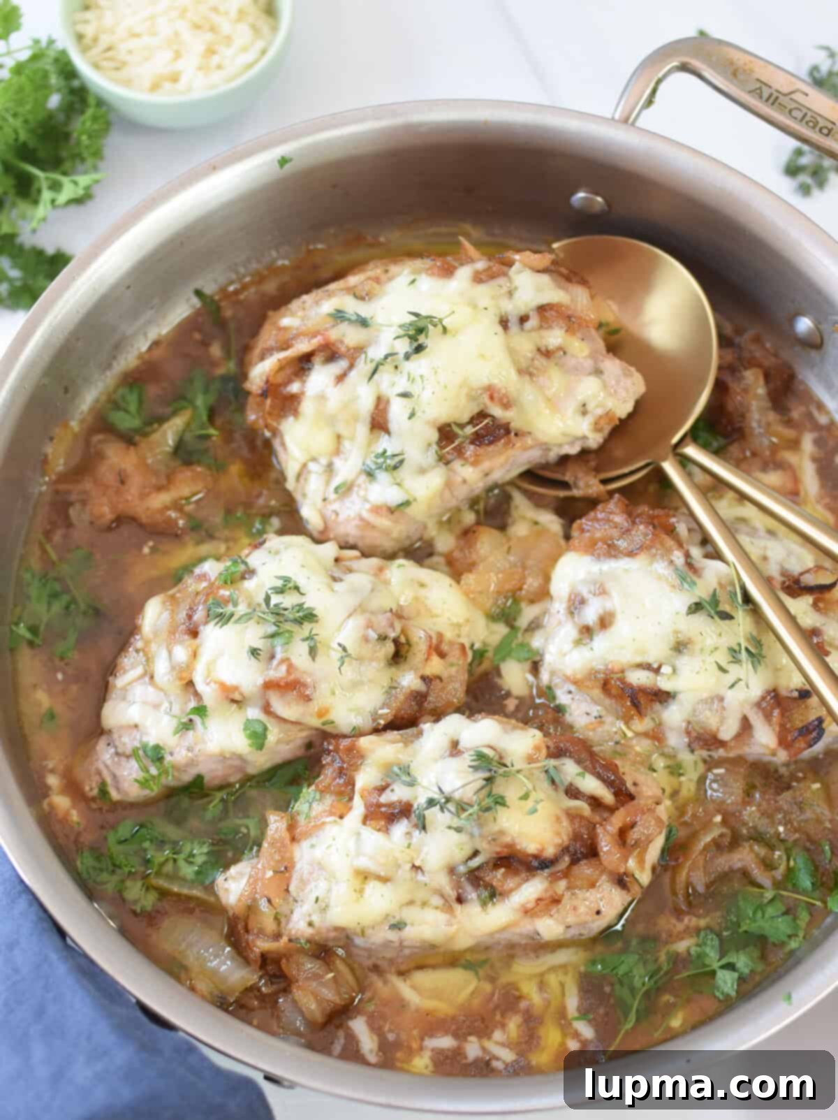 Smothered French Onion Pork Chops 5 Plated French Onion Pork Chops served with elegant gold serving spoons