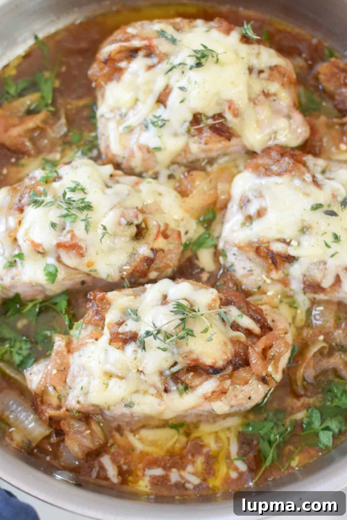 Smothered French Onion Pork Chops 8 French Onion Pork Chops with fresh thyme garnish