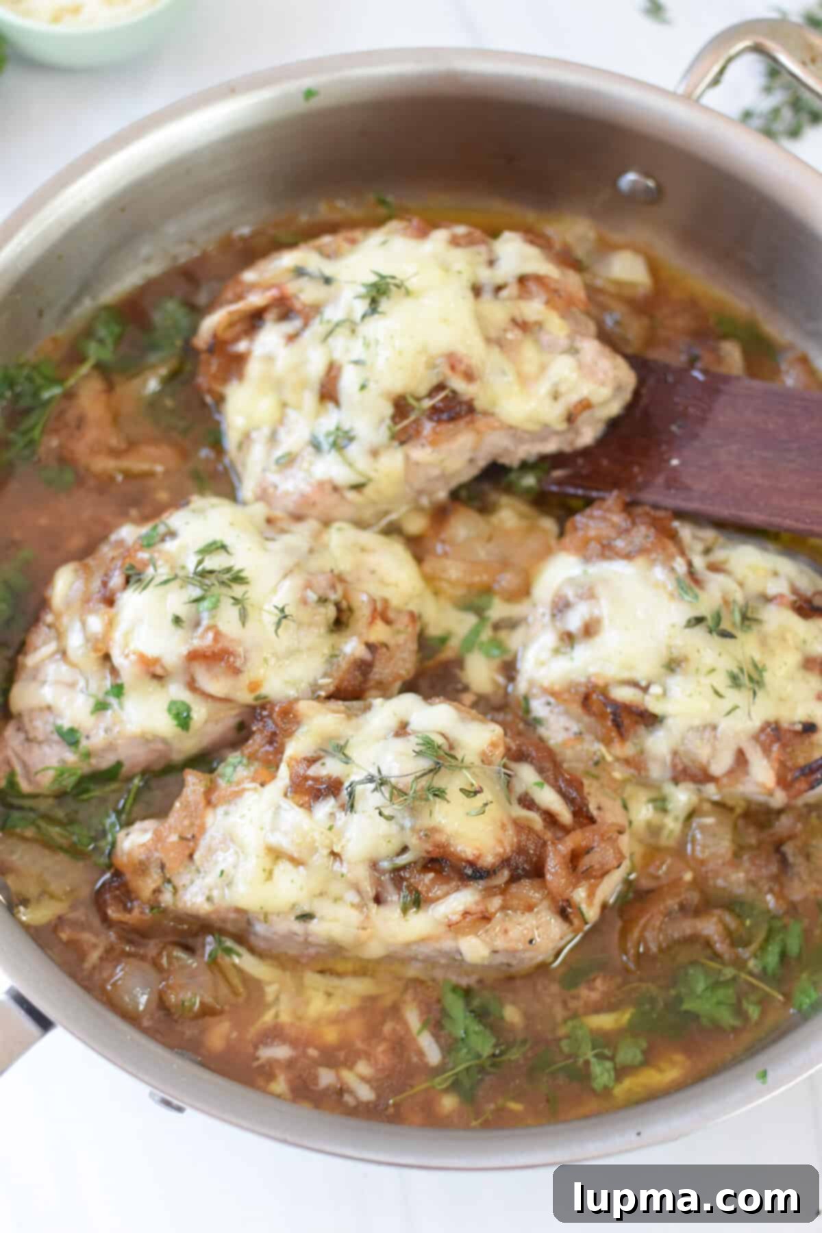 Smothered French Onion Pork Chops 9 French Onion Pork Chops with a wooden spatula for serving