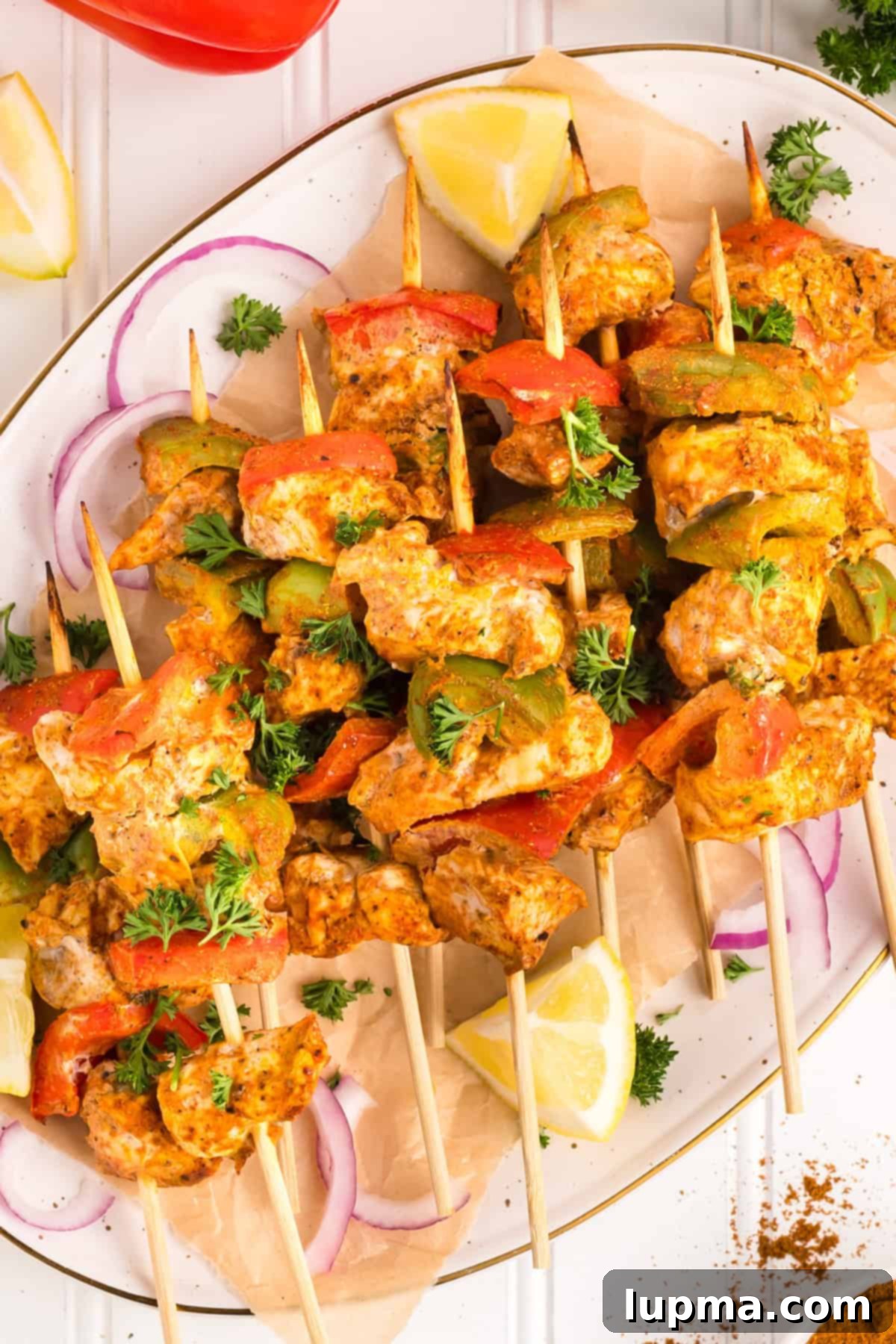 Smoky Chicken Tikka Skewers 11 Chicken Tikka Kebabs on skewers on a plate