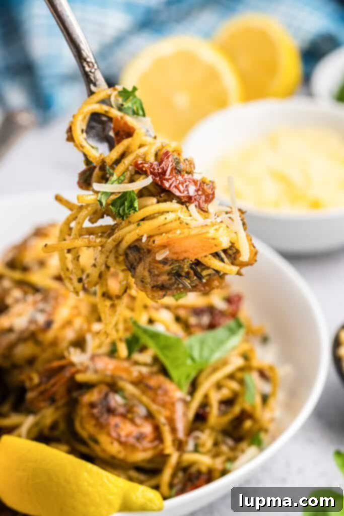 Vibrant Shrimp Pesto Pasta 4 Shrimp Pesto Pasta on a fork against a blurred background