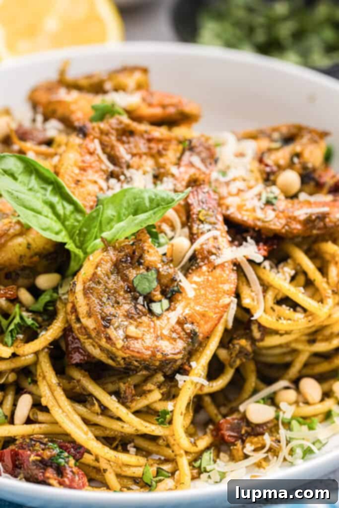 Vibrant Shrimp Pesto Pasta 9 Shrimp Pesto Pasta in a bowl with fresh basil garnish