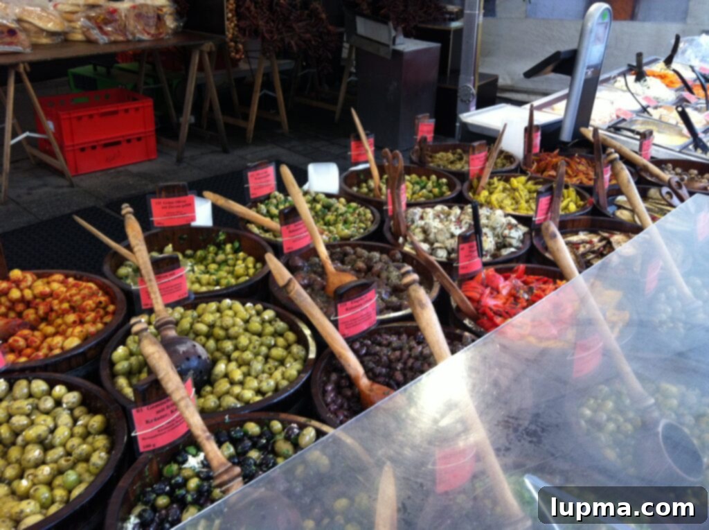A lavish olive bar with various types of olives and antipasti at Viktualienmarkt, Munich, Germany
