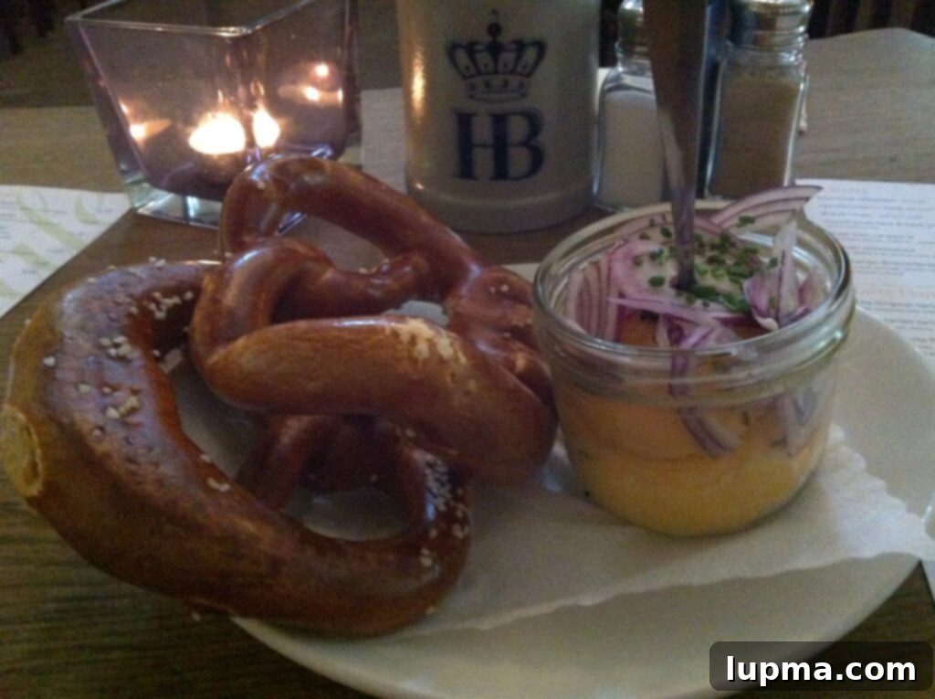 A traditional Bavarian pretzel served with cheese spread in Munich, Germany