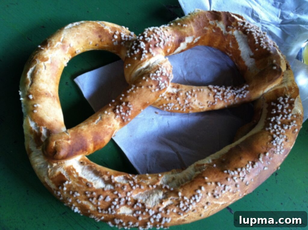 A close-up shot of a large pretzel, often called a 'Brezn,' in Munich, Germany