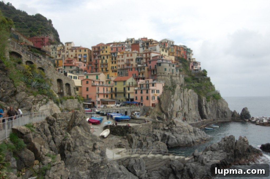 Cinque Terre and Santa Margherita Italy Coastal Charms 10 Breathtaking panoramic view of a Cinque Terre village from a hiking trail, with the sea stretching beyond