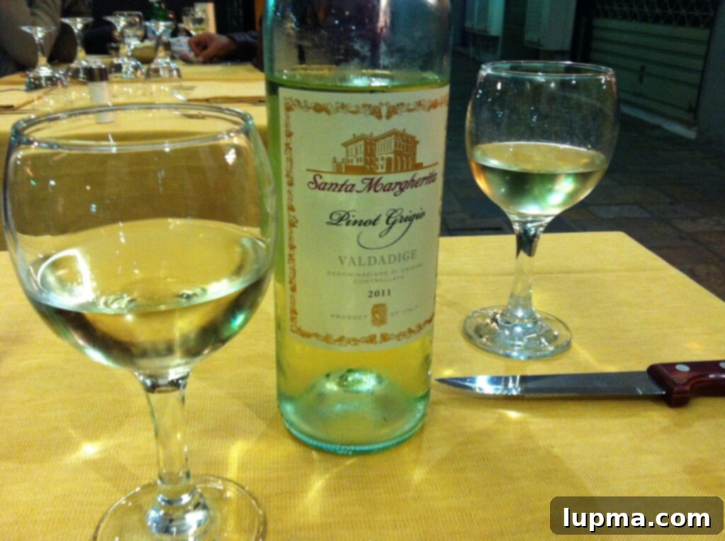 Cinque Terre and Santa Margherita Italy Coastal Charms 7 A glass of exquisite Italian wine, likely Santa Margherita Pinot Grigio, in a beautiful setting