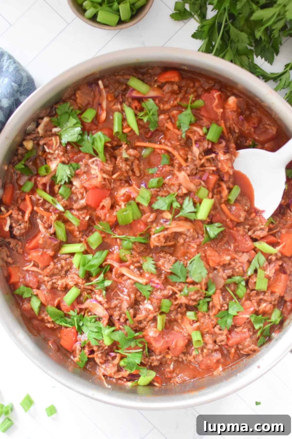 Mediterranean Beef and Cabbage Stir-fry with a white spoon 