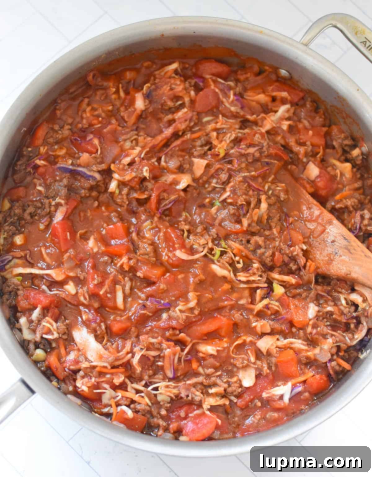 Mediterranean Beef and Cabbage Stir-fry with wooden spoon 