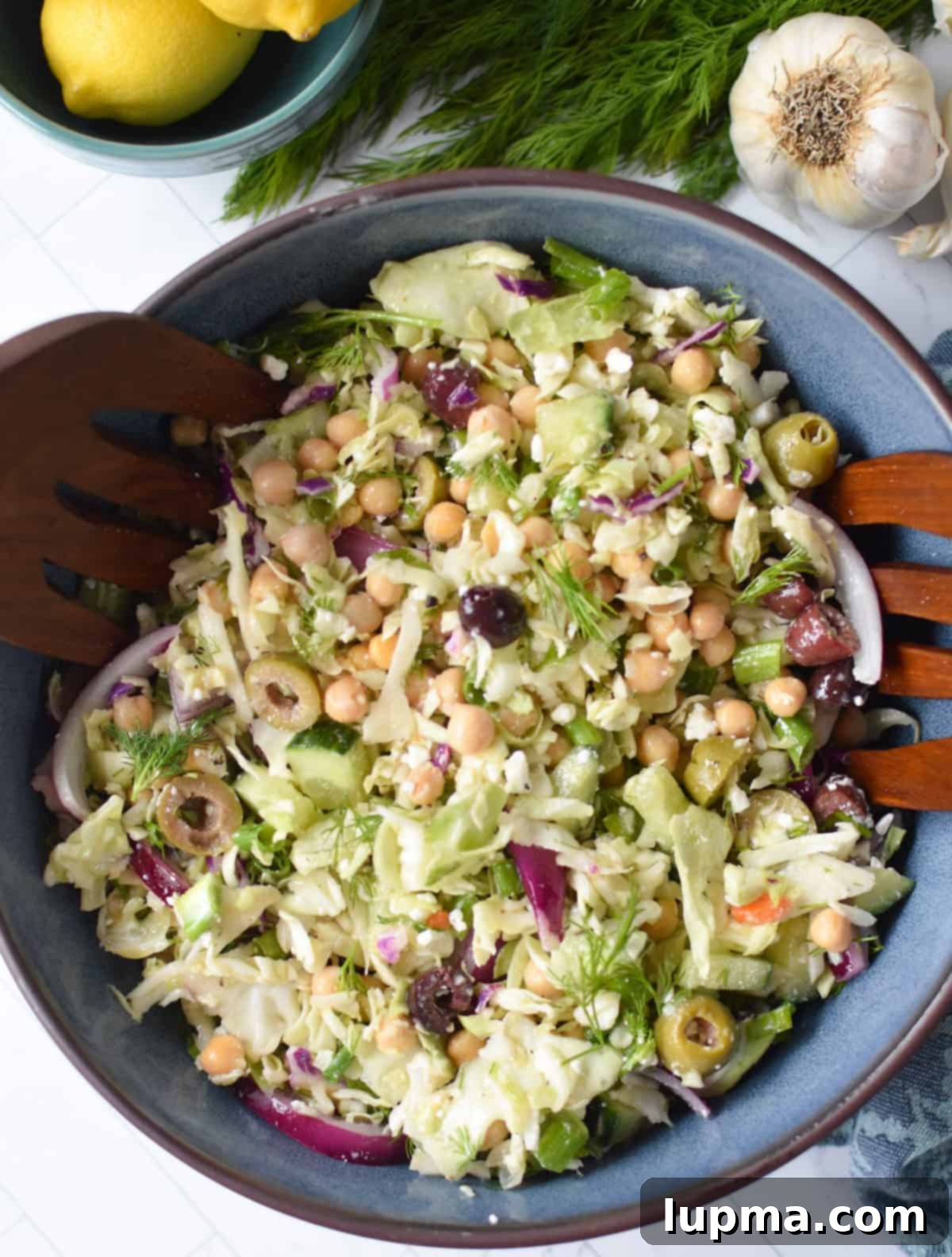 Lahanosalata Greek cabbage salad in a rustic wooden bowl.