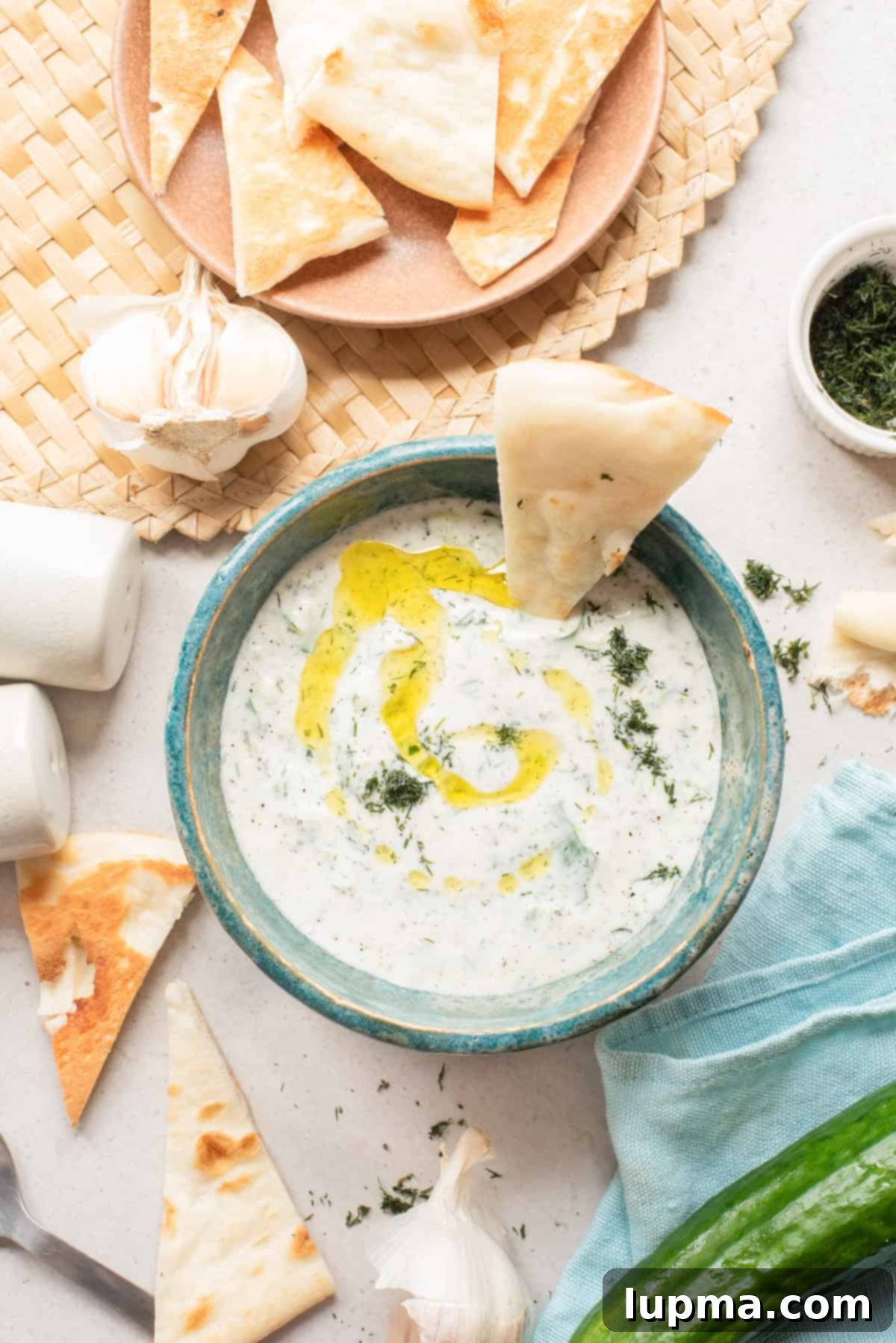 Cucumber Garlic Yogurt Sauce in a bowl with pita