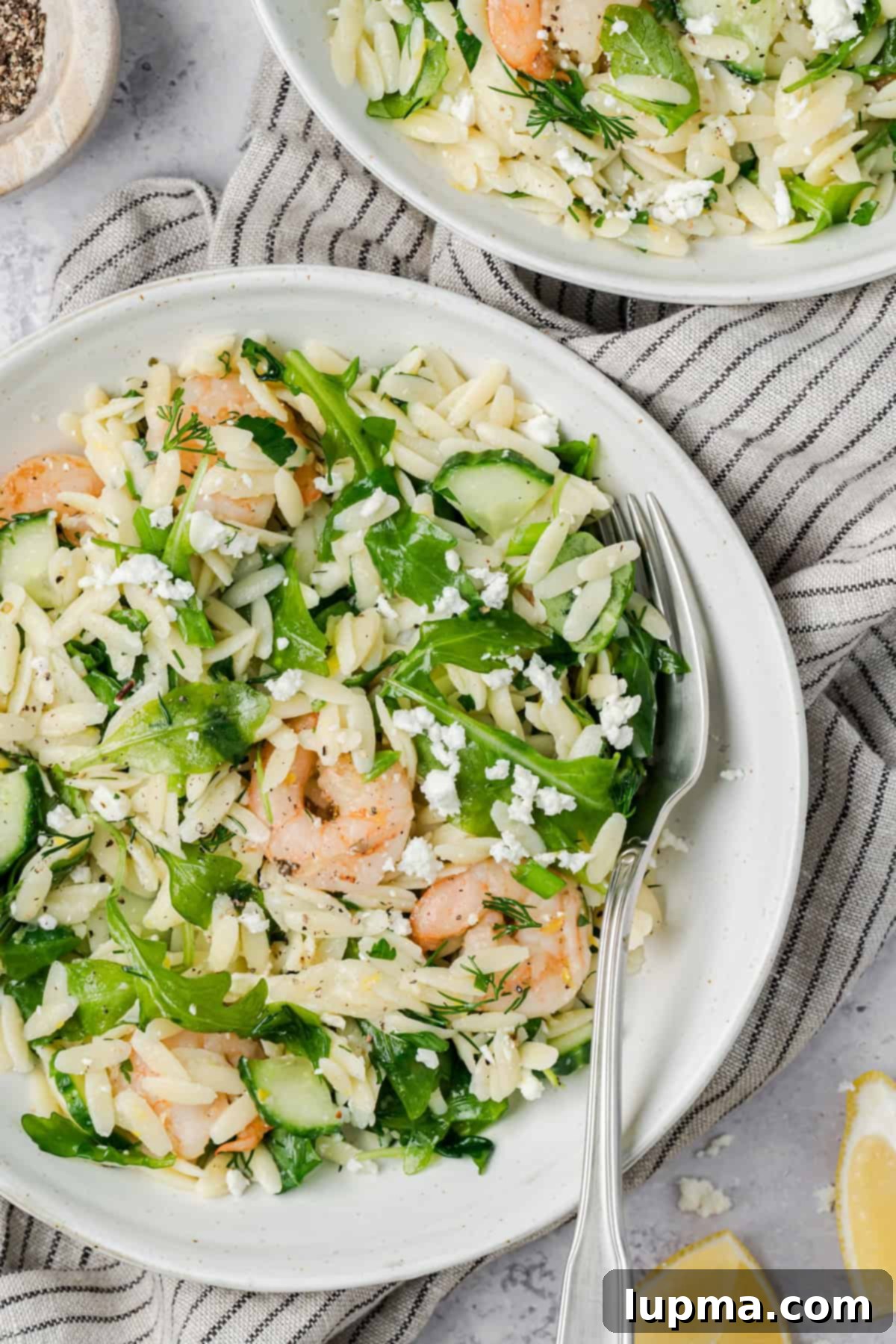 Shrimp Orzo Salad with Lemon-Dill Dressing 12 Lemony Shrimp Orzo Pasta Salad on a white plate with a fork