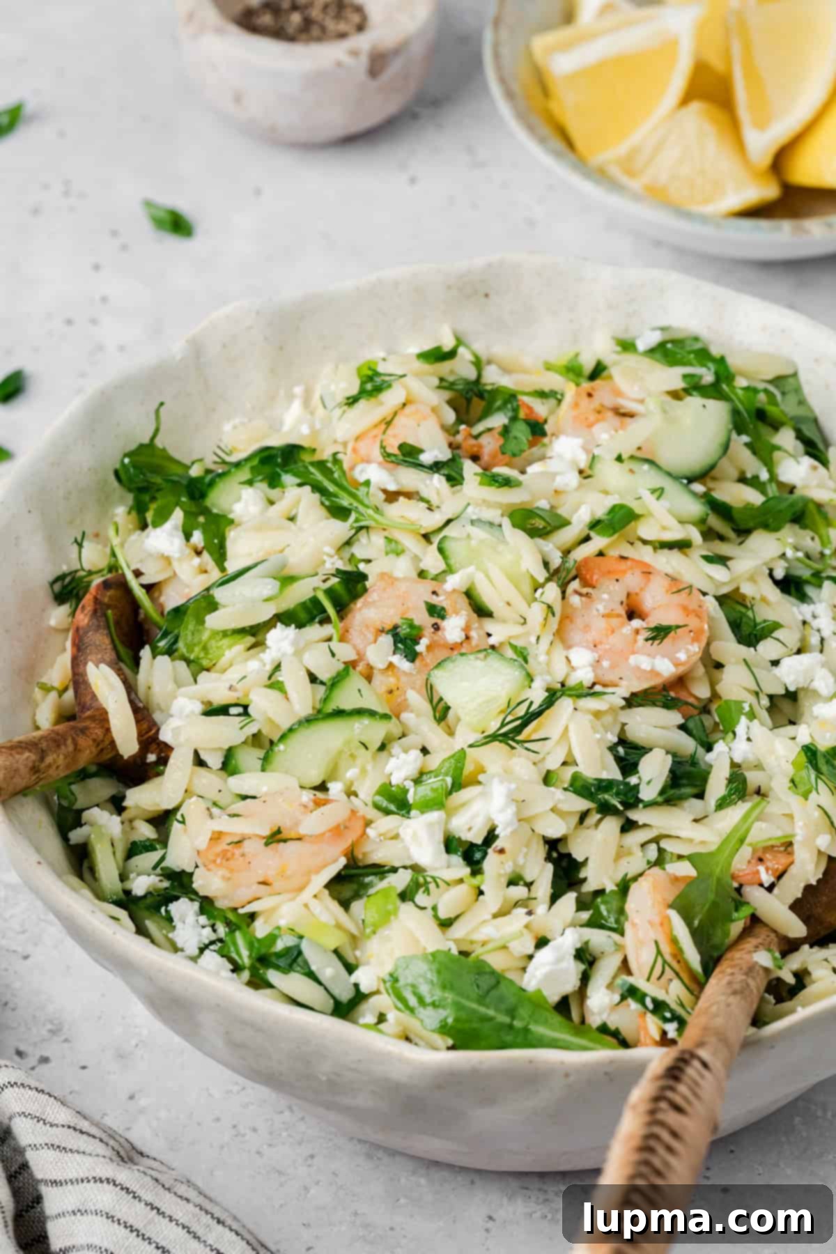 Shrimp Orzo Salad with Lemon-Dill Dressing 7 Shrimp Orzo Pasta Salad in a white bowl with a wooden spoon