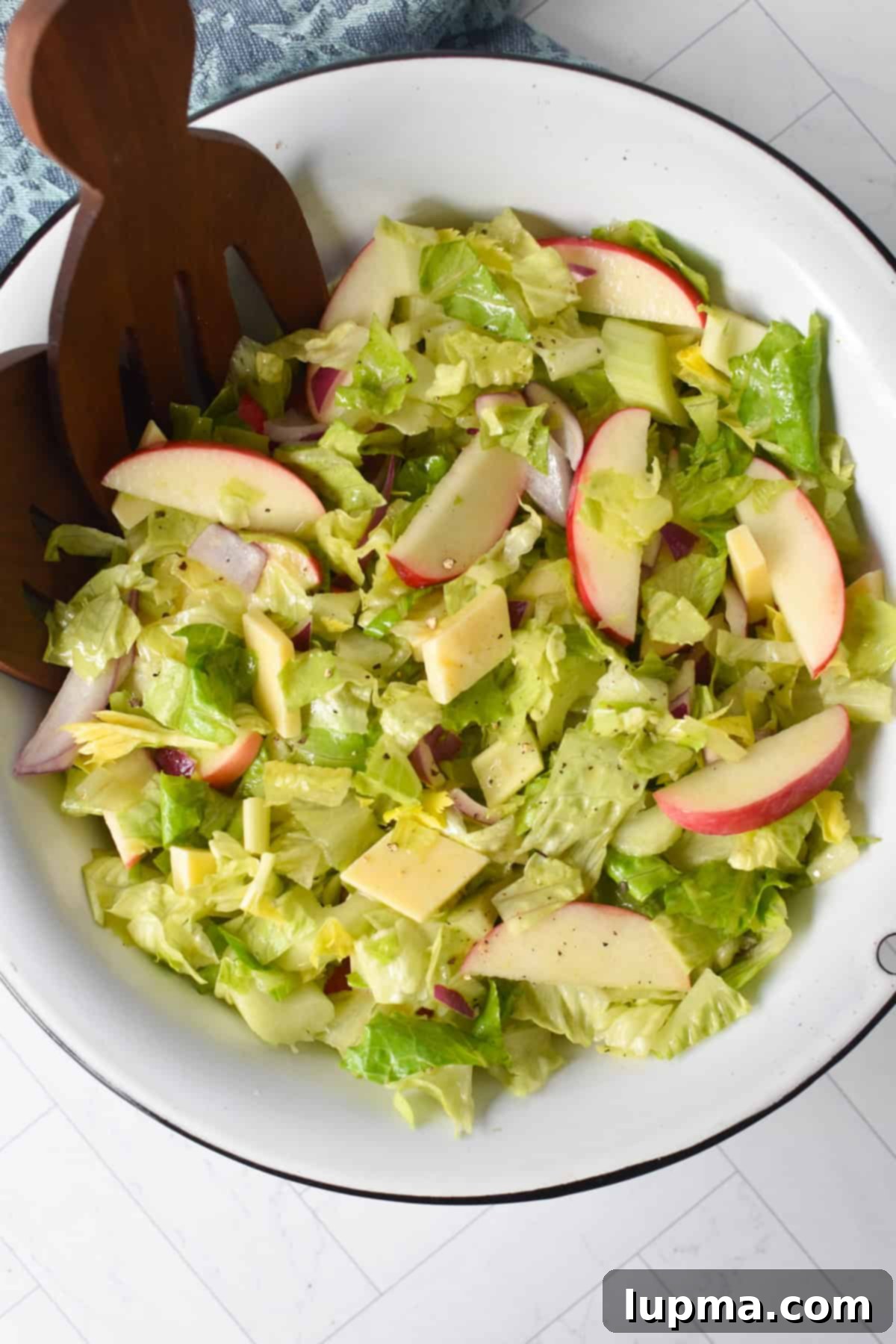 Apple and Celery Crunch: A Refreshing Salad Recipe 2 Apple and Celery Salad in a white bowl with wooden serving spoons