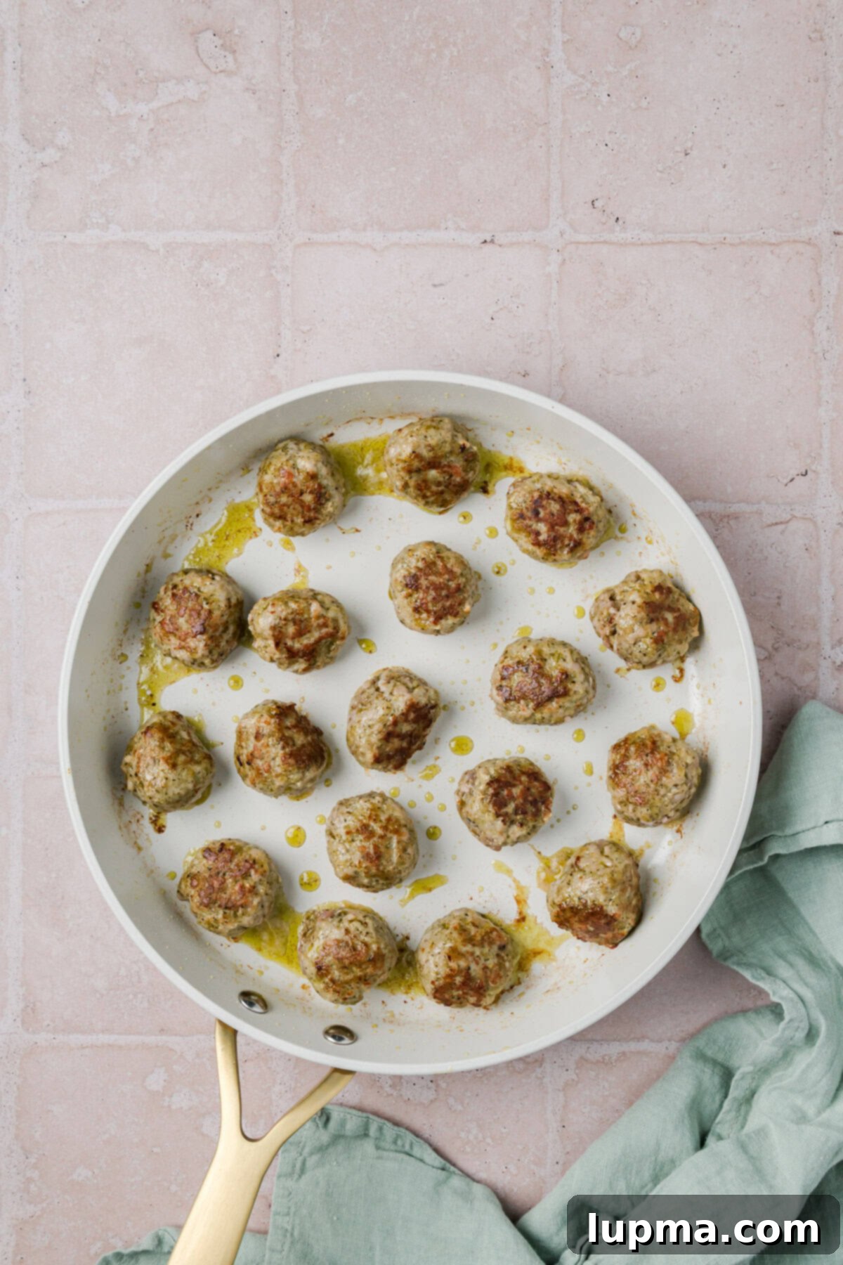 Turkish-Spiced Pesto Turkey Bites 7 Meatballs and Pesto in a skillet