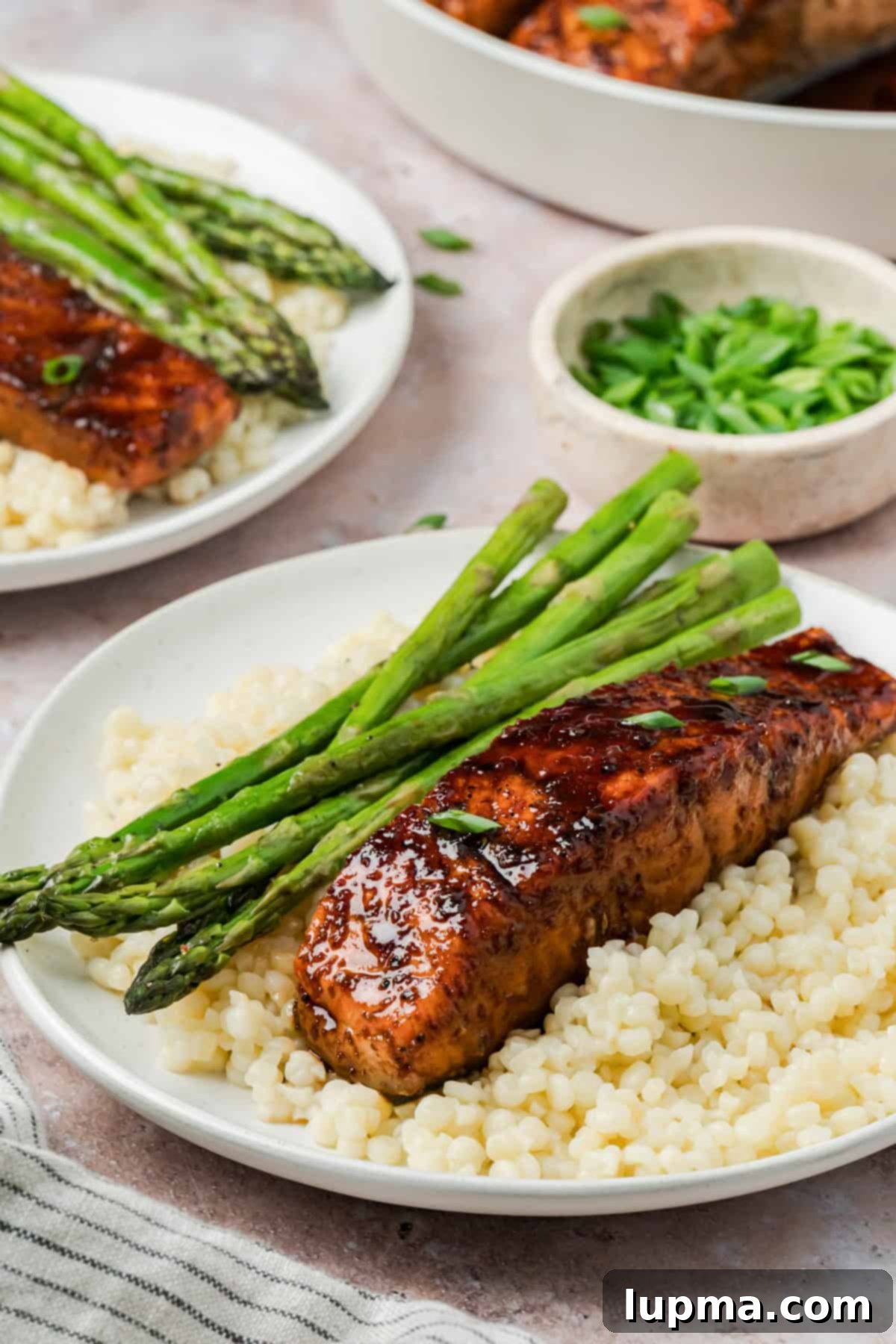 Bourbon Glazed Salmon on a white plate with asparagus