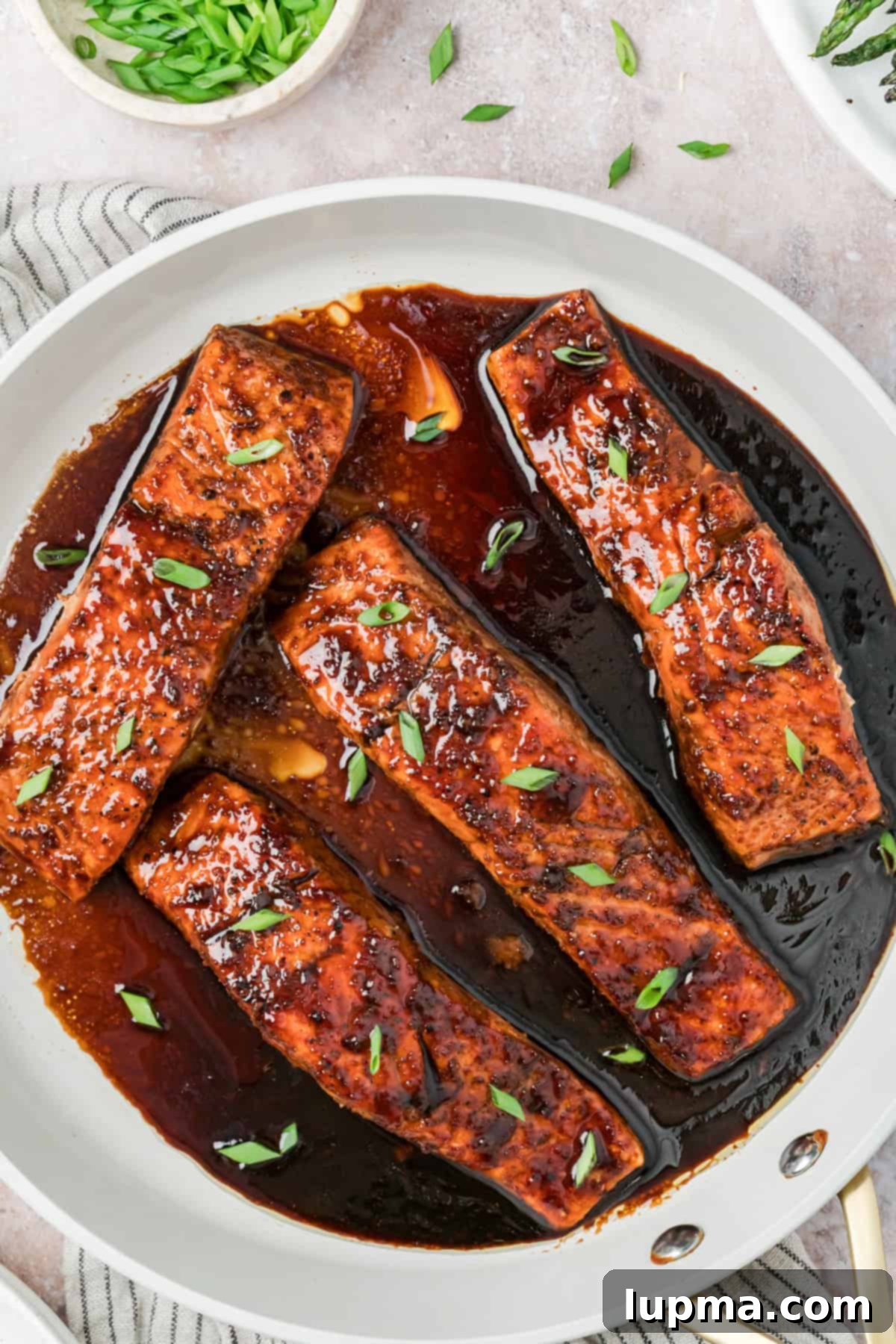 Bourbon Glazed Salmon in skillet with glaze 