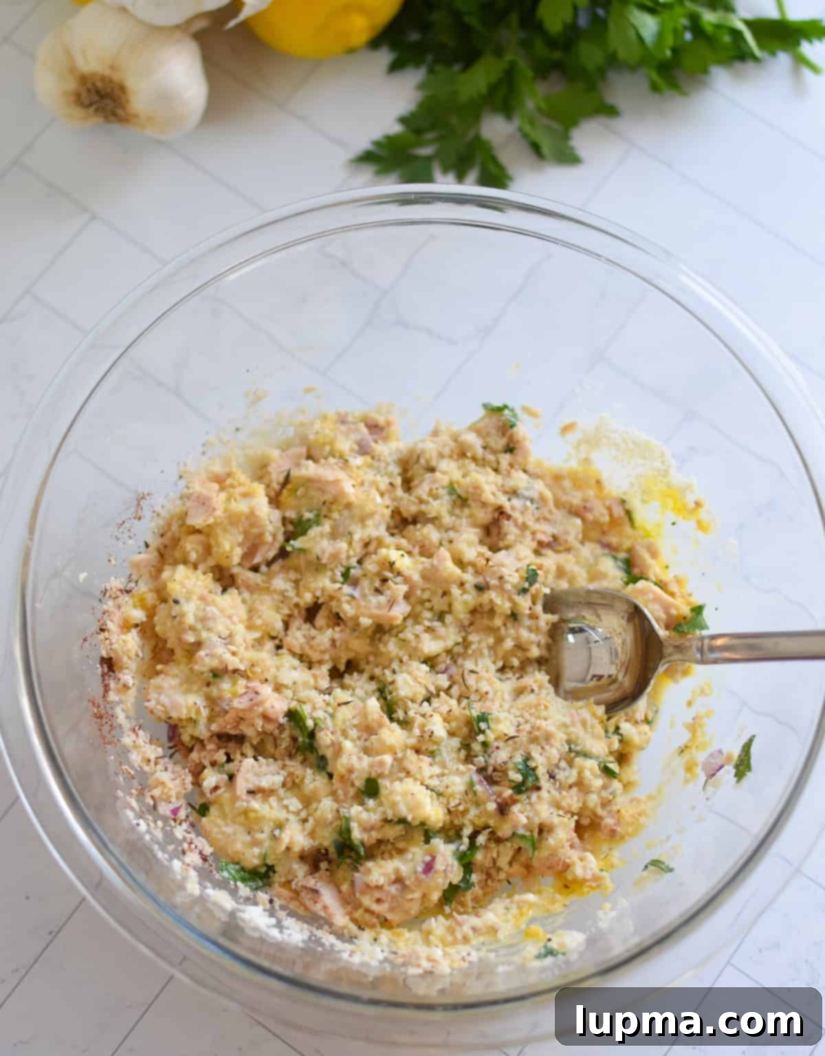 Salmon Patties recipe recipe ingredients mixed in a clear bowl