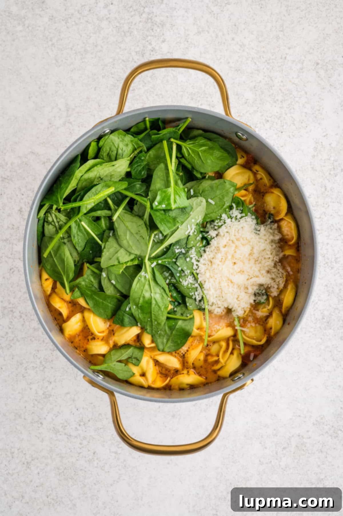 Creamy Tortellini Soup spinach in a pot