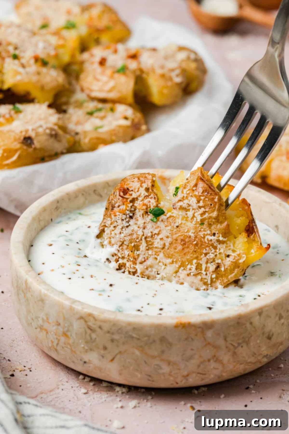 Crispy smashed potatoes topped with parmesan cheese