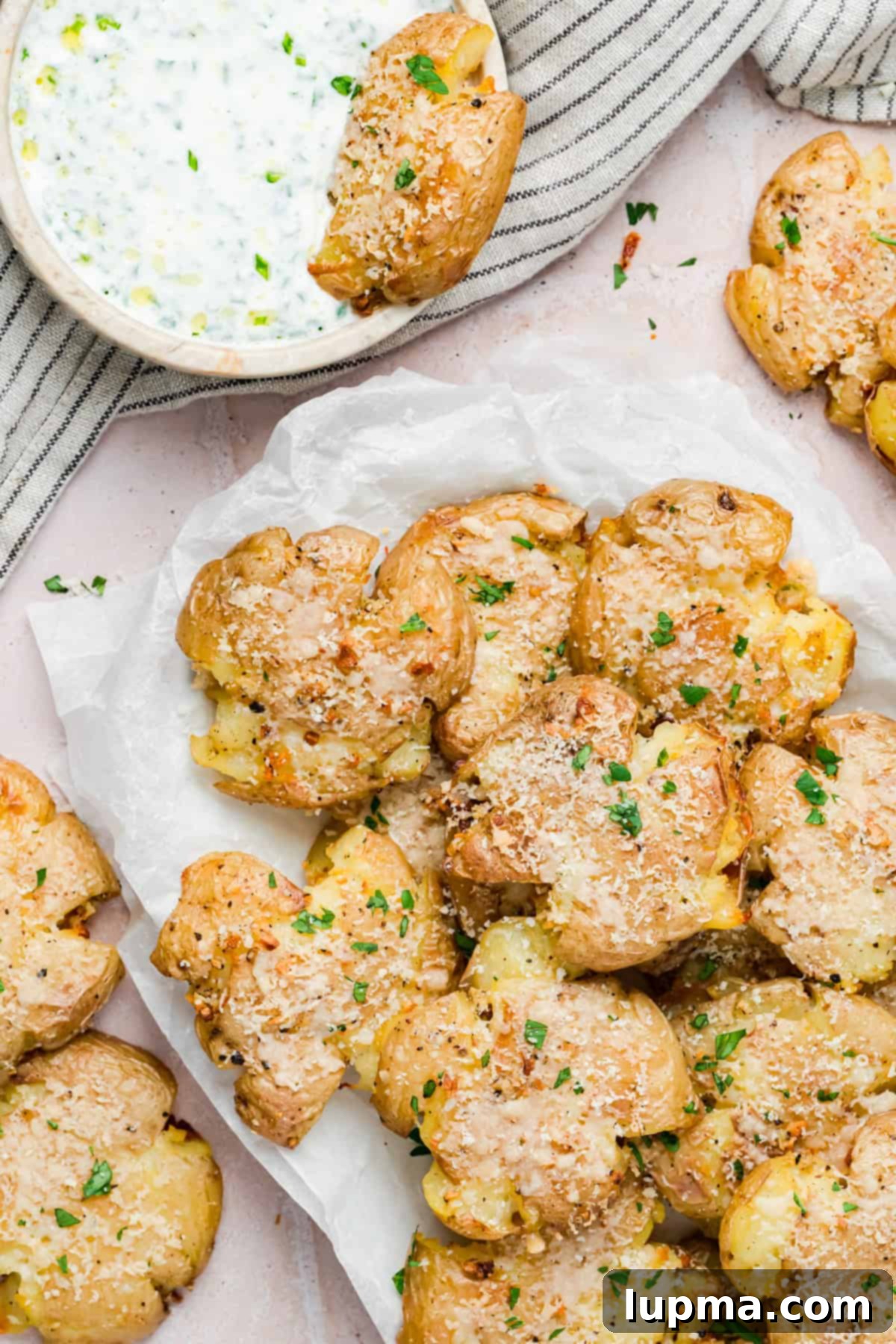 Oven baked garlic smashed potatoes with herbs