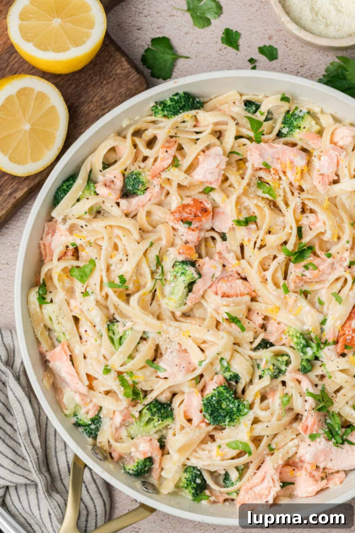 Creamy Alfredo Salmon Pasta served with broccoli and Parmesan cheese