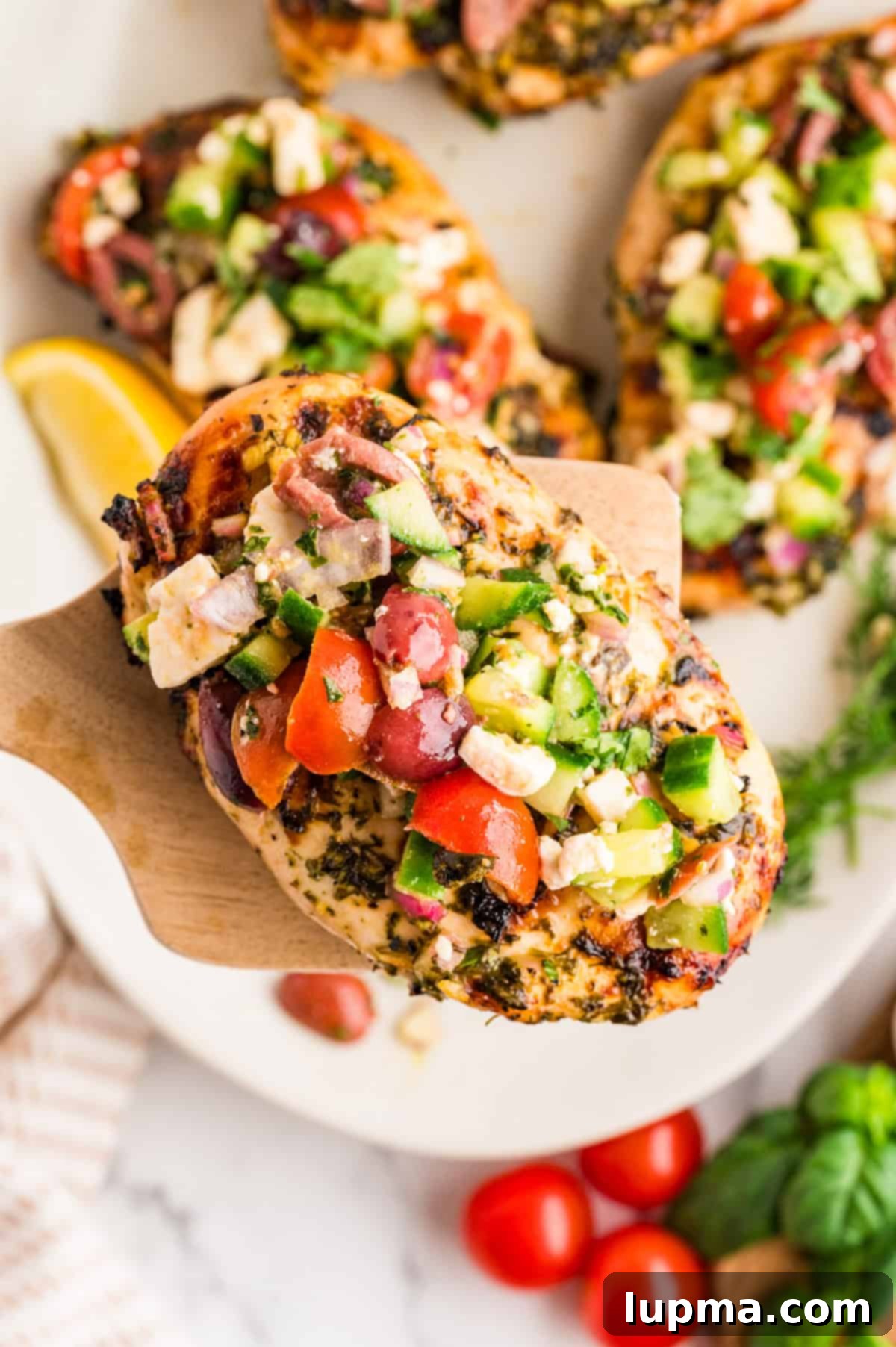 A simple yet elegant grilled Mediterranean chicken breast, ready to be topped.