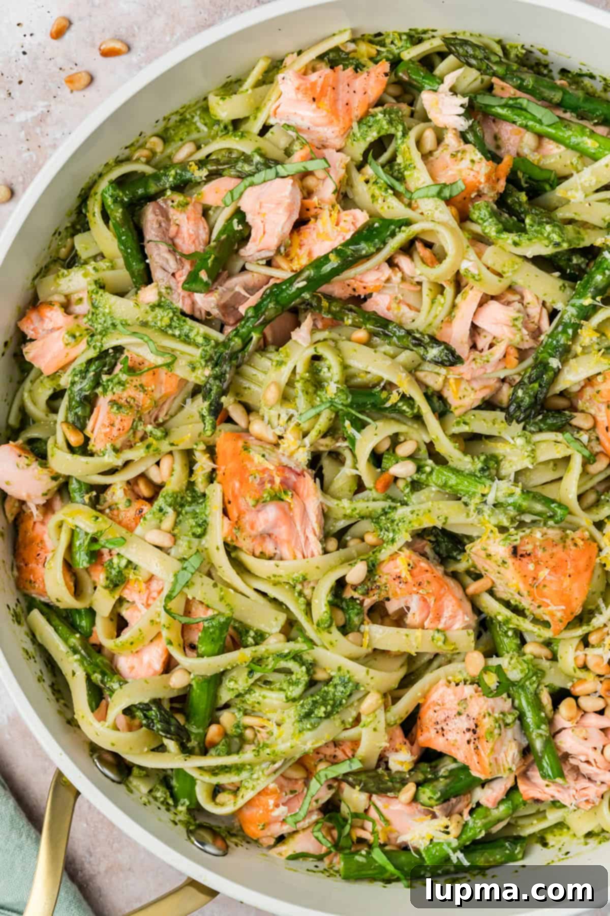 Pesto Pasta with Salmon in a white skillet