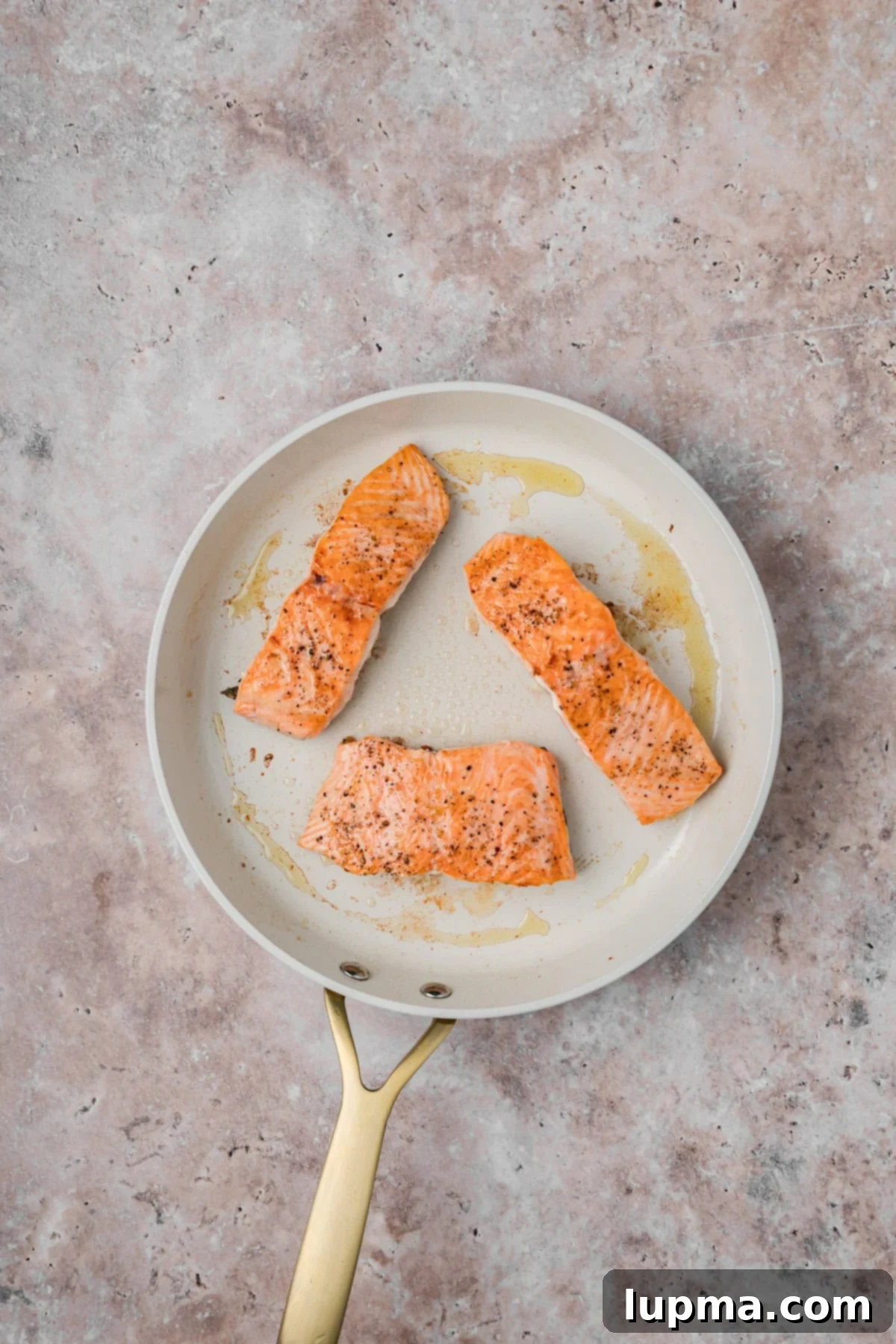 Salmon seared in a skillet