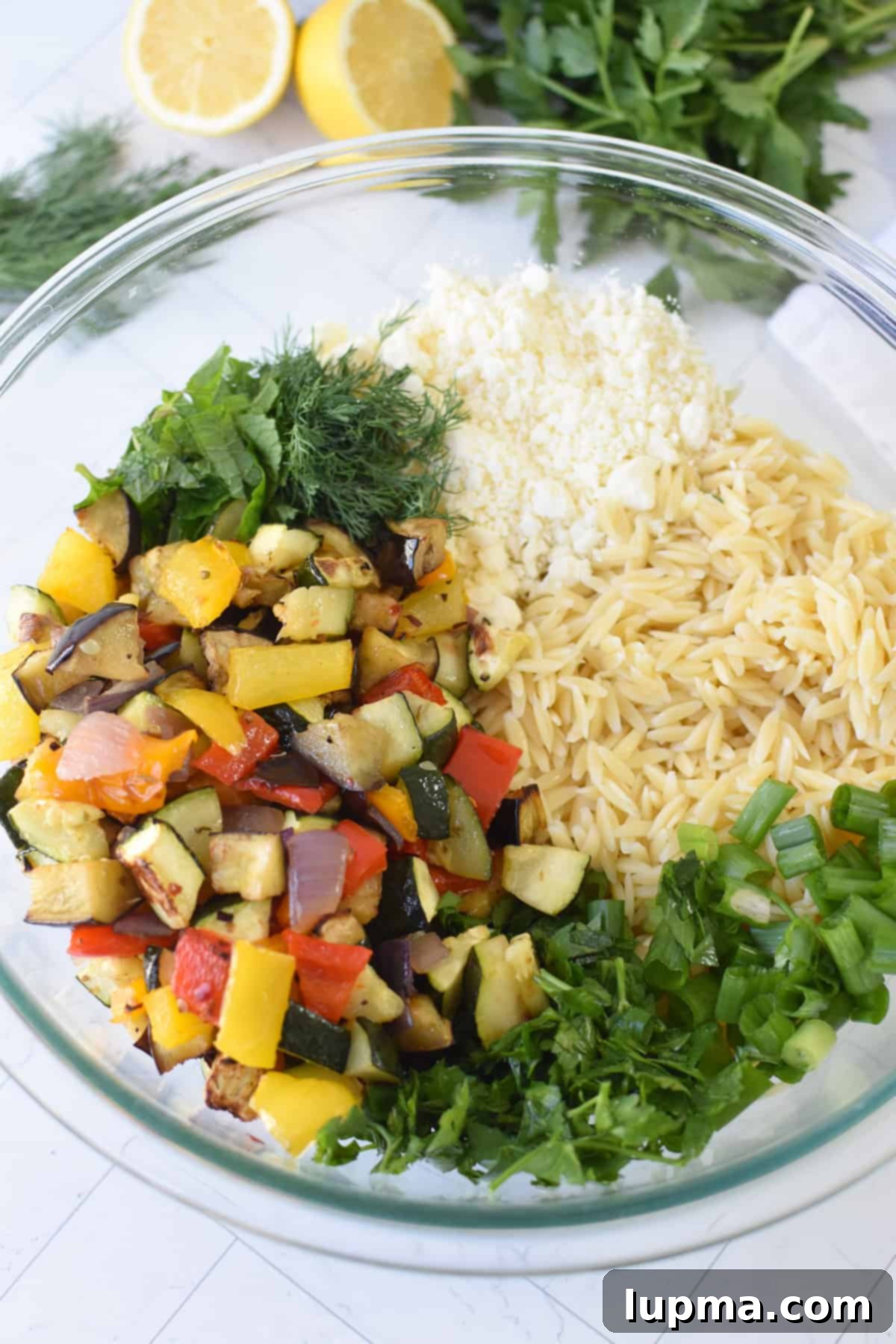 Roasted Vegetables in a glass bowl for an orzo salad 