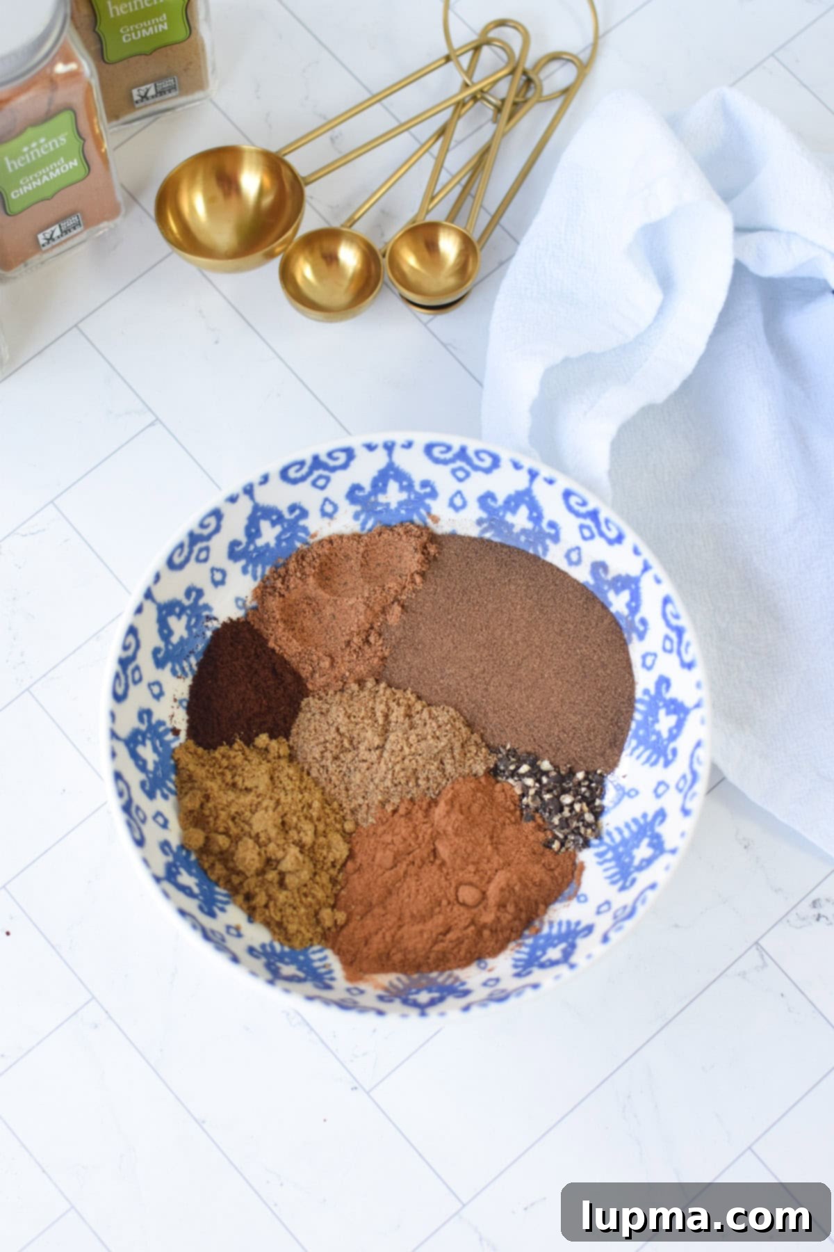 Close-up of spices being measured for Lebanese Seven Spice Blend, highlighting freshness