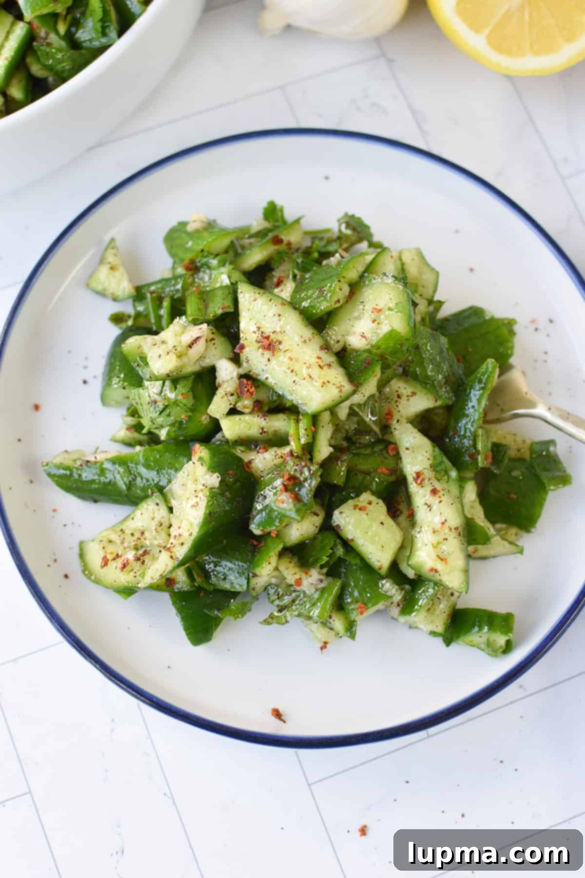 Close-up of Tangy Smashed Cucumber Salad with Sumac, Mint, and Lemon Dressing