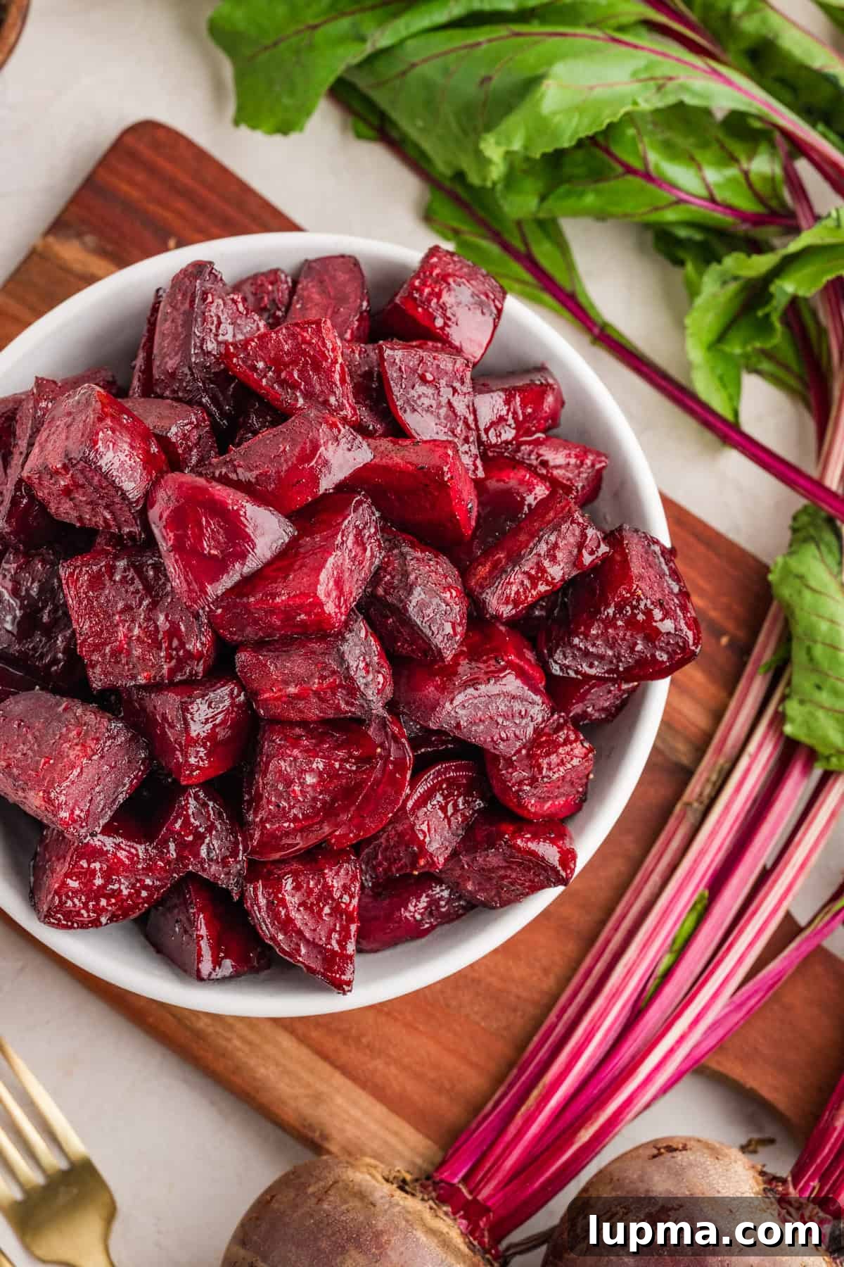 Oven roasted beets on a white serving bowl with caramelized edges