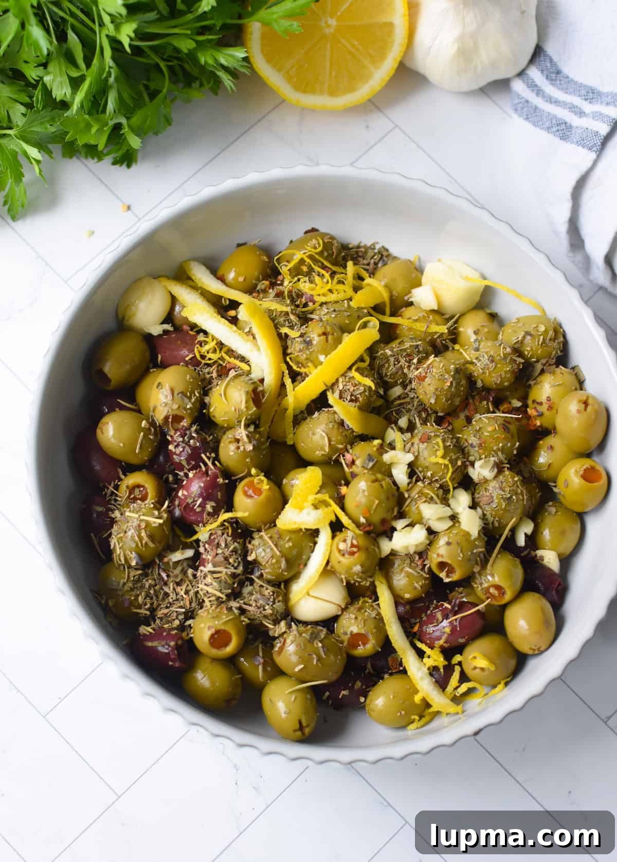 Mediterranean Warm Lemon Olives with Herb Garlic Dip — 10 Minutes 7 Warm Olives ingredients in a bowl