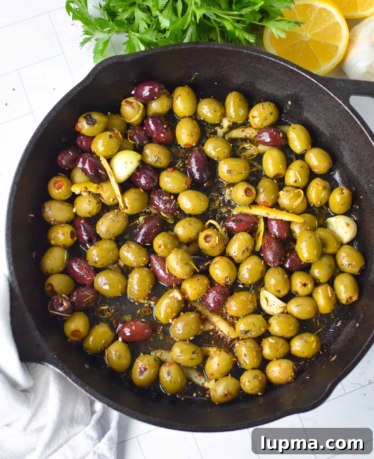 Mediterranean Warm Lemon Olives with Herb Garlic Dip — 10 Minutes 8 Warm Olives with Mediterranean Herbs in a Cast Iron Skillet