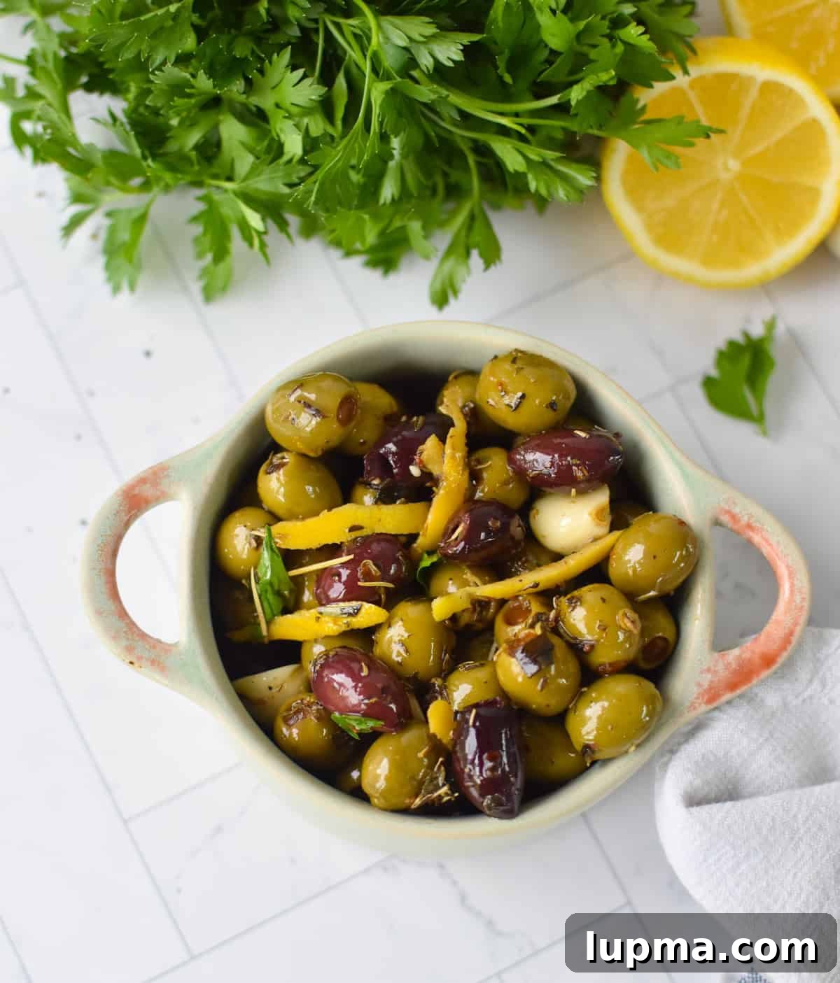 Mediterranean Warm Lemon Olives with Herb Garlic Dip — 10 Minutes 9 Bowl of warm Mediterranean olives with fresh parsley garnish