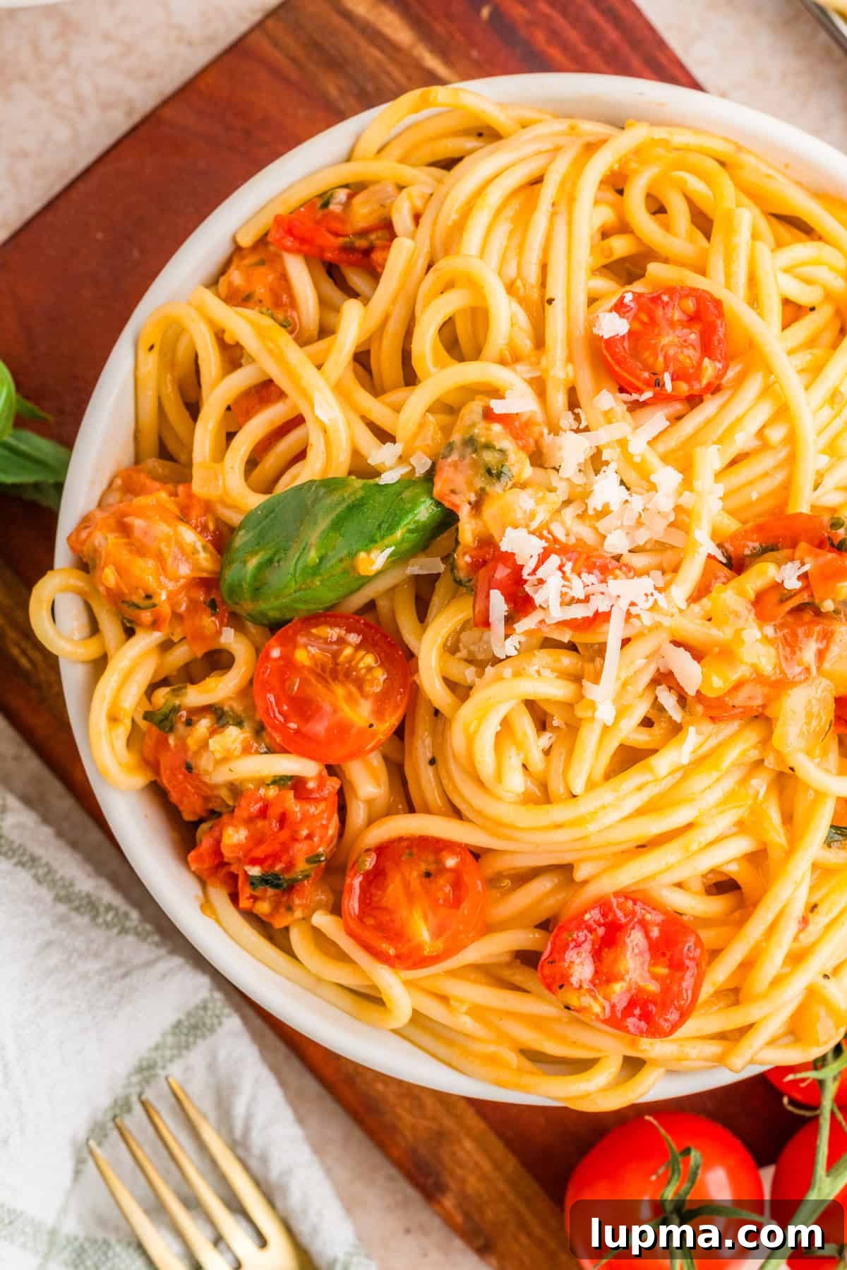 Cherry Tomato and Basil Pasta Recipe 2 Bowl of cherry tomato basil pasta topped with fresh basil and shaved parmesan