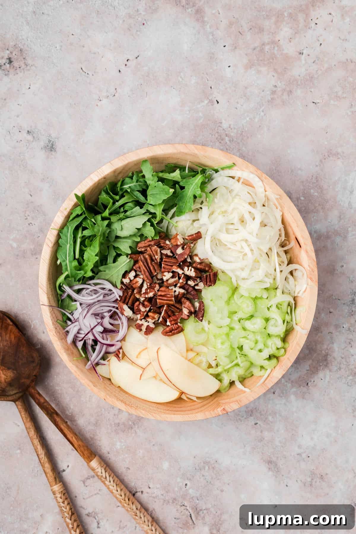Easy Apple Fennel Salad mixing ingredients in a bowl 
