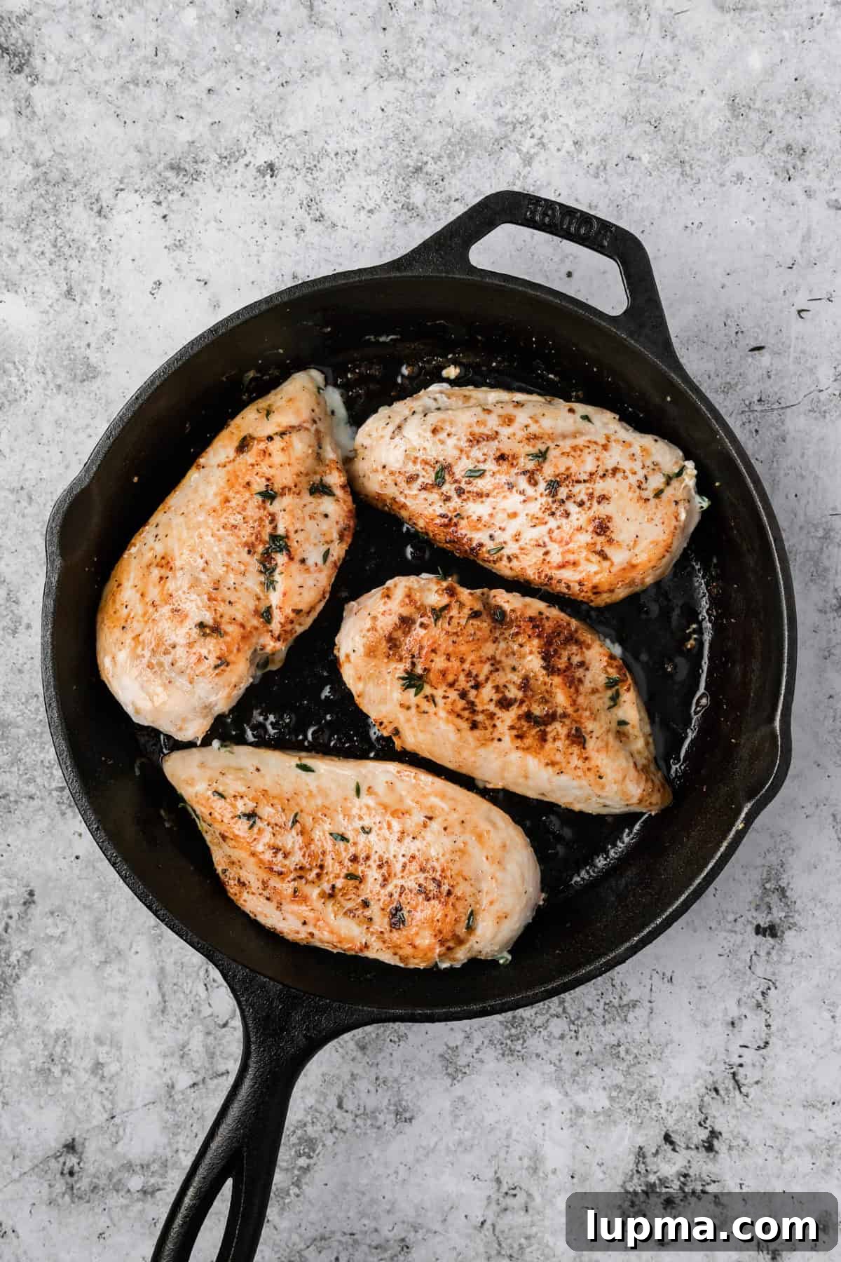 Apple Brie Stuffed Chicken searing in skillet 