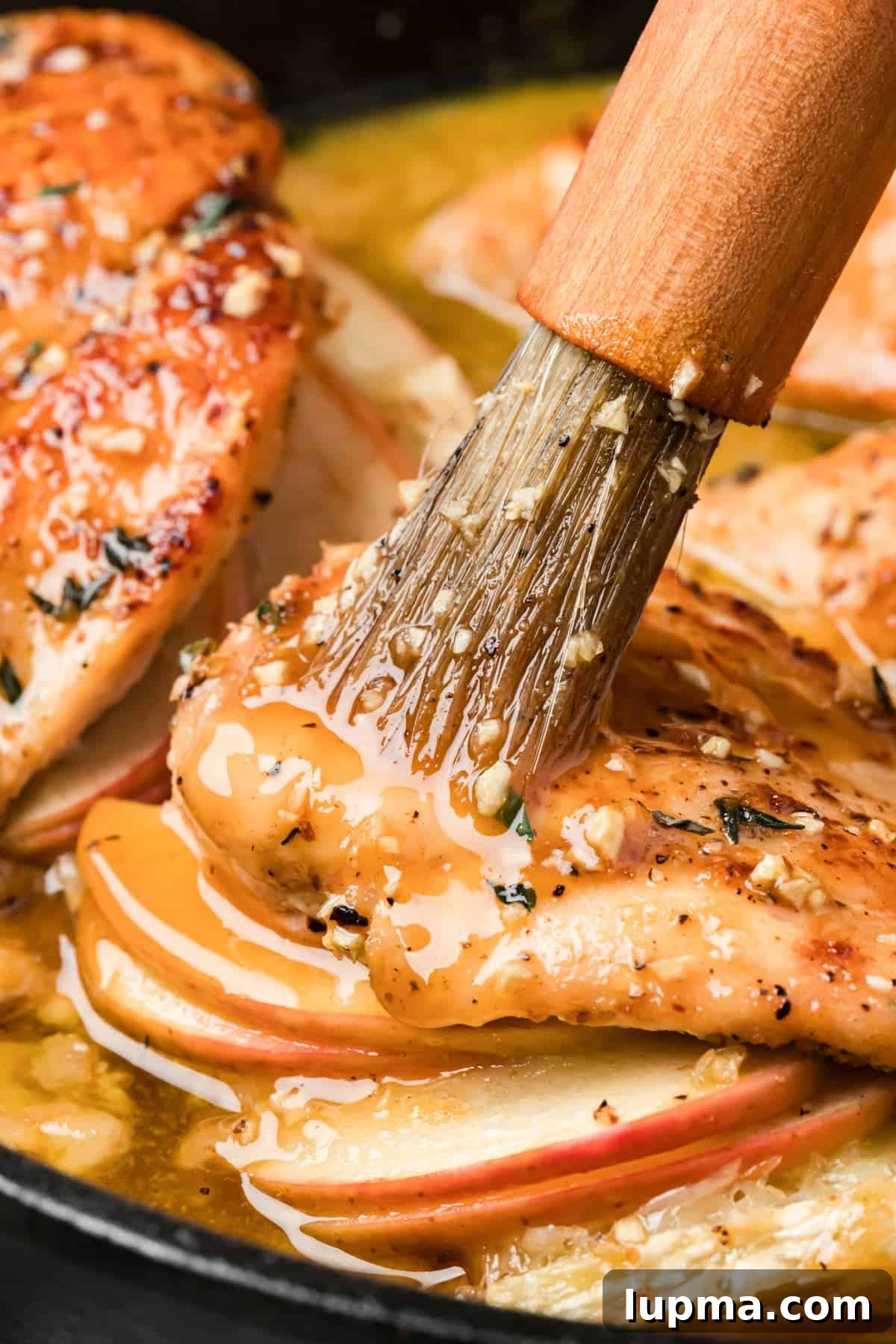 Brushing chicken with mpale glaze 